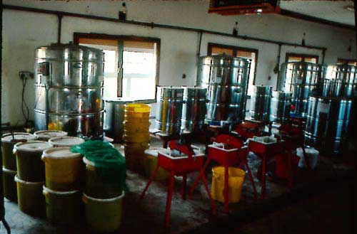 Honey presses in the foreground and water jacketed settling  tanks in the background at the honey processing centre of Northwestern Bee Products, Kabompo, Zambia, which buys, processes and exports honey and wax from mostly traditional barkhive beekeeping.