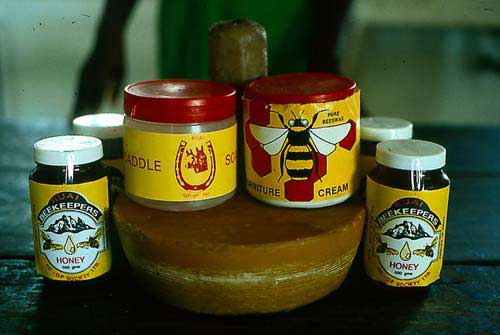 The various products sold by the Ruai Beekeepers' Cooperative in Kenya (from left to right): Honey, saddle soap (similar recipe as furniture polish paste, 4.11.5(1), without aromatic oil), candles, rendered wax, furniture cream polish and honey.