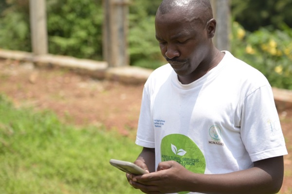 Daniel Nshimiyimana, young farmer monitoring market prices online