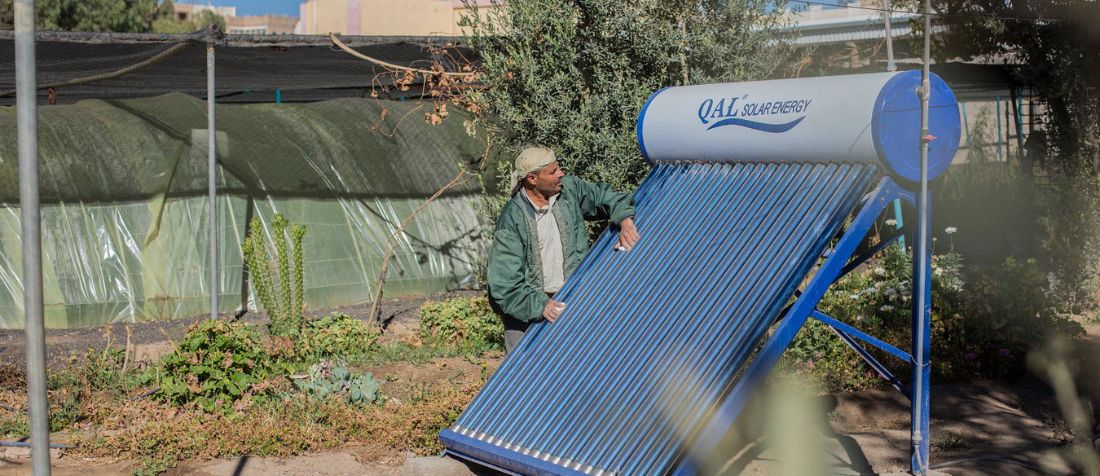 Yemen - A farmer is cleaning the solar power cells of the farm in the targeted area supported by FAO.